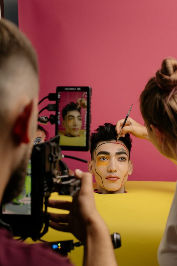 Behind the scenes of a creative makeup artistry session in a vibrant studio setting.